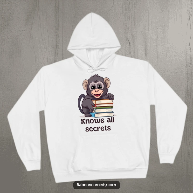 Funny hoodie featuring a mischievous baboon peeking over a stack of books and giggling, perfect for cozy reading moments.