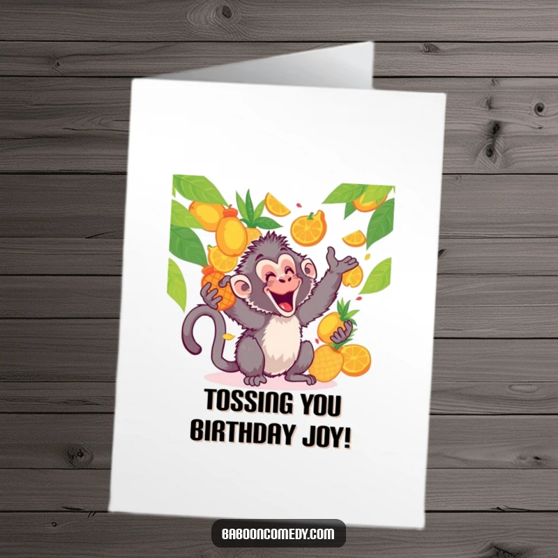 Funny Free Printable Birthday Card: Kawaii baboon gleefully tossing vibrant tropical fruits high in the air, laughing with pure birthday delight.