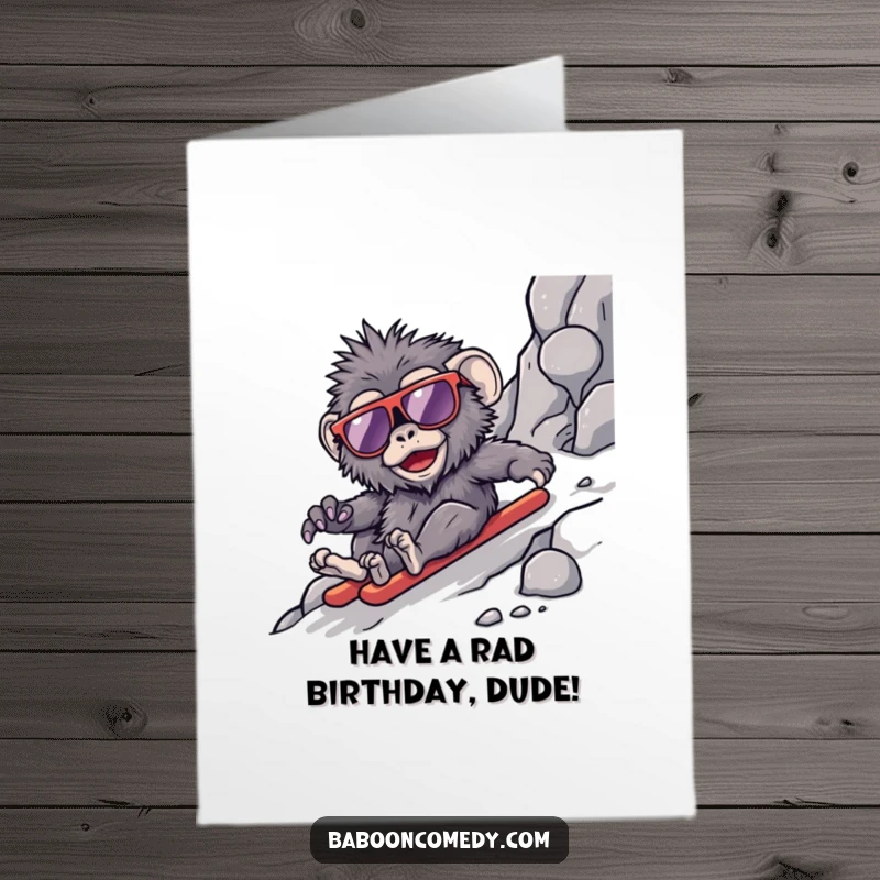 Funny Free Printable Birthday Card: A kawaii baboon sports cool oversized sunglasses while sliding down a rocky slope with flair.