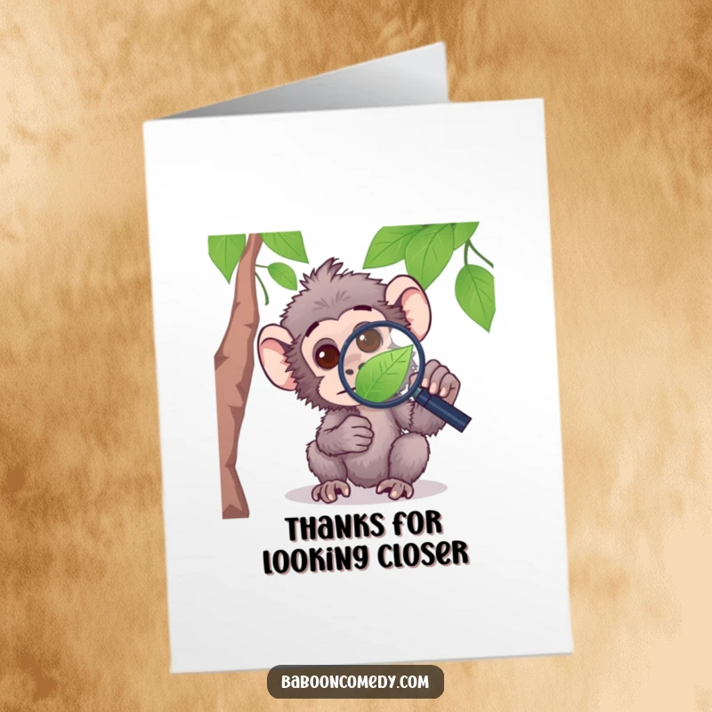 Funny Free Printable baboon thank you card, a curious baboon investigating a leaf with a magnifying glass.