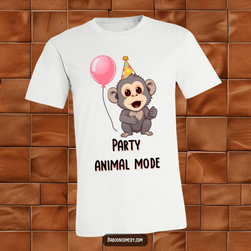 Funny T-shirt showing a surprised baboon wearing a festive party hat and holding a colorful balloon, capturing surprise and fun.