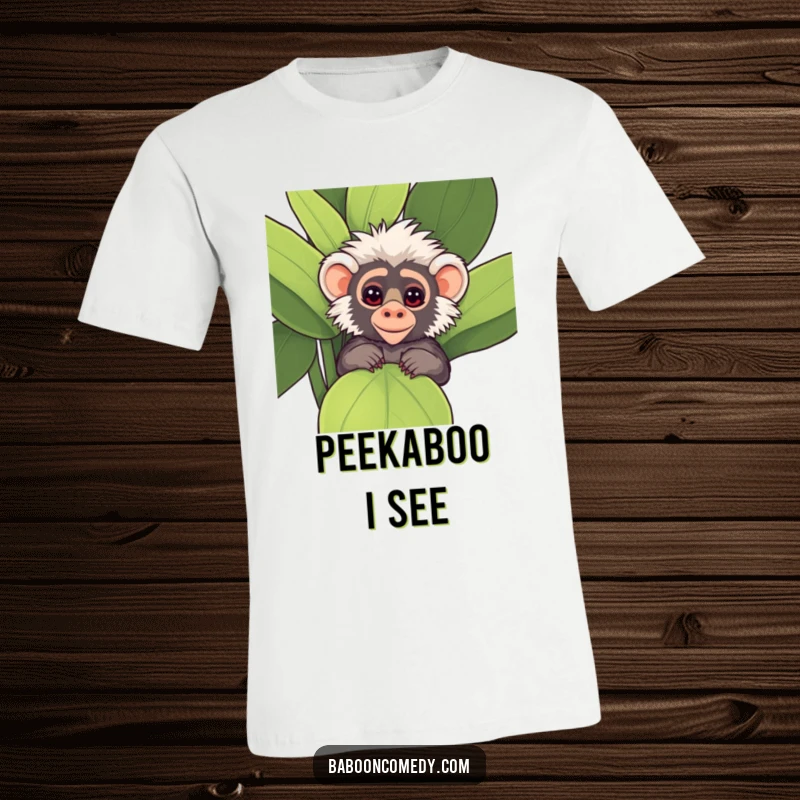 Funny Kawaii Baboon T-Shirt, peeking playfully from behind a large, leafy plant with mischievous, sparkling eyes.