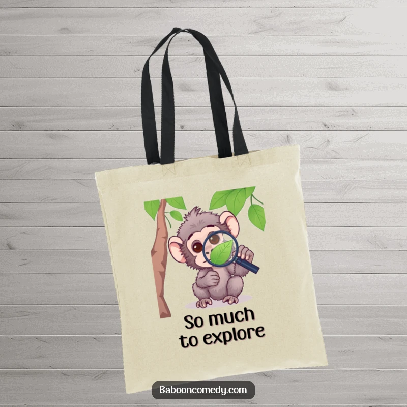 Funny tote bag with a curious baboon peering through a magnifying glass at a leaf, perfect for carrying books and more.